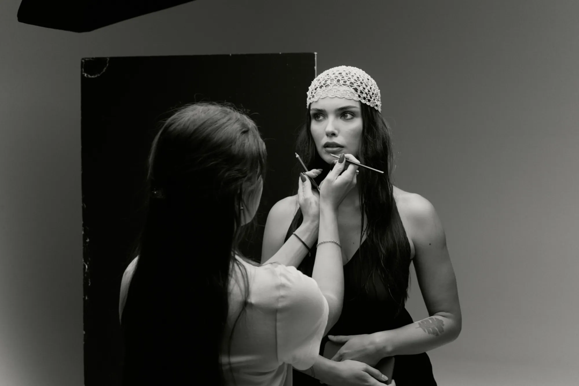 Anna Lysak applying makeup on a model in the studio